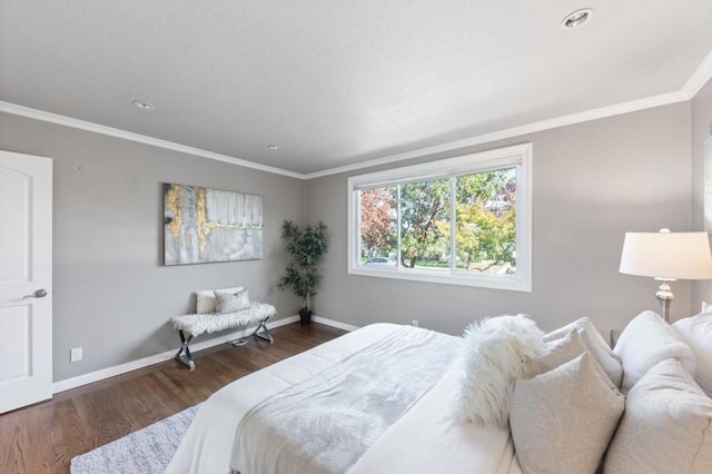 bedroom with dark hardwood / wood-style flooring and crown molding