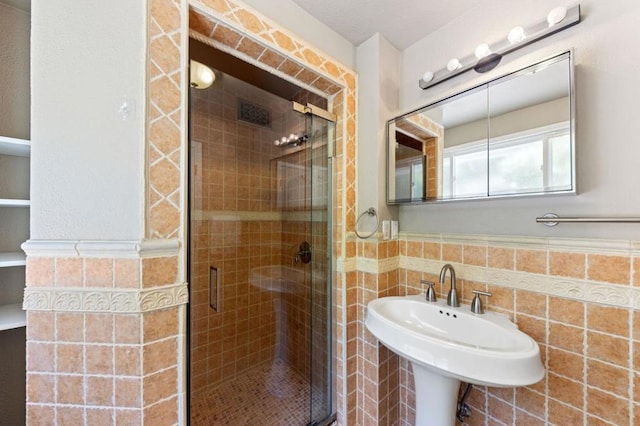 bathroom with tile walls and walk in shower