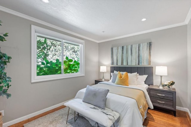 bedroom with light hardwood / wood-style flooring and crown molding