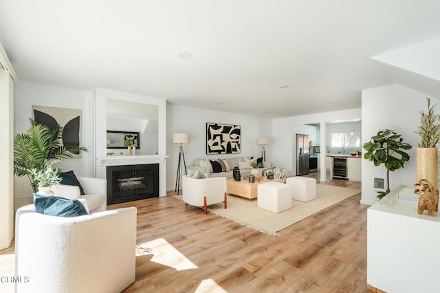 living room featuring light hardwood / wood-style flooring and beverage cooler