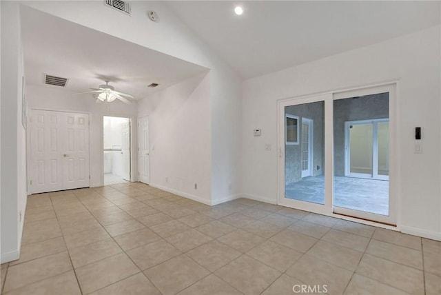 tiled empty room featuring ceiling fan and lofted ceiling