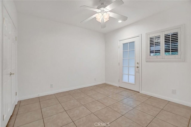 tiled empty room with ceiling fan