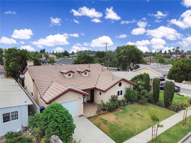 view of front of property with a garage and a front lawn