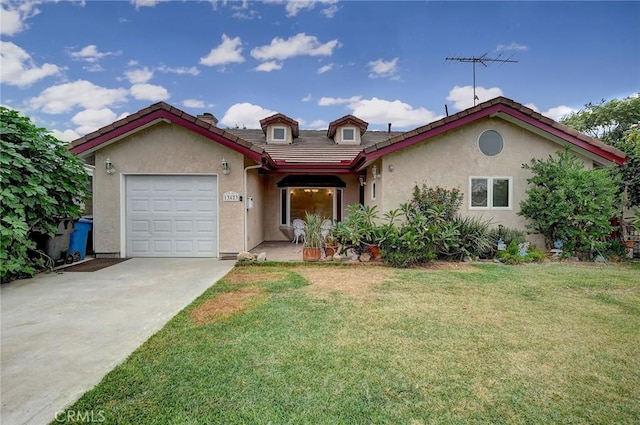 mediterranean / spanish home featuring a front lawn and a garage