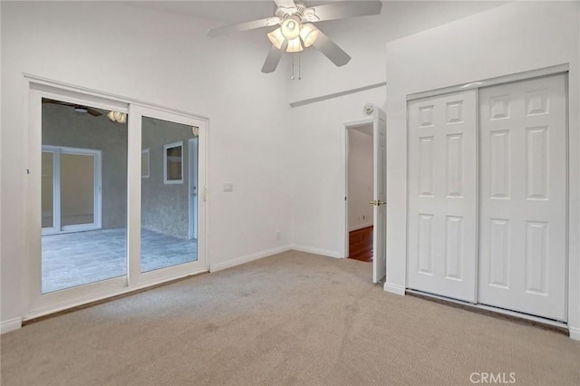 unfurnished bedroom with ceiling fan, light colored carpet, a closet, and access to exterior