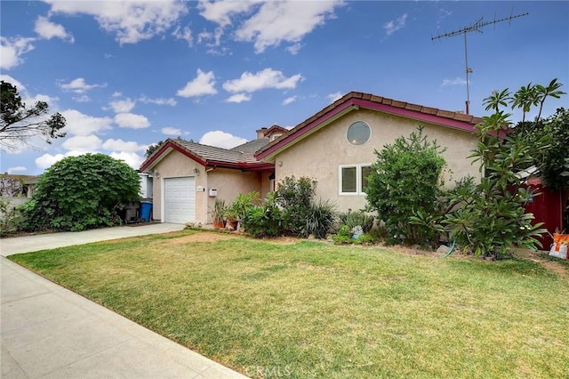 view of front of house with a front yard and a garage