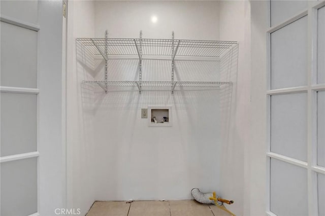 washroom featuring light tile patterned floors and hookup for a washing machine