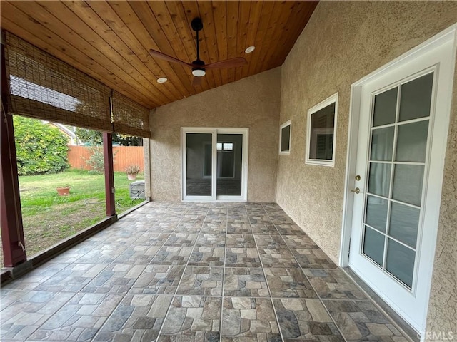 unfurnished sunroom featuring ceiling fan, wooden ceiling, and lofted ceiling