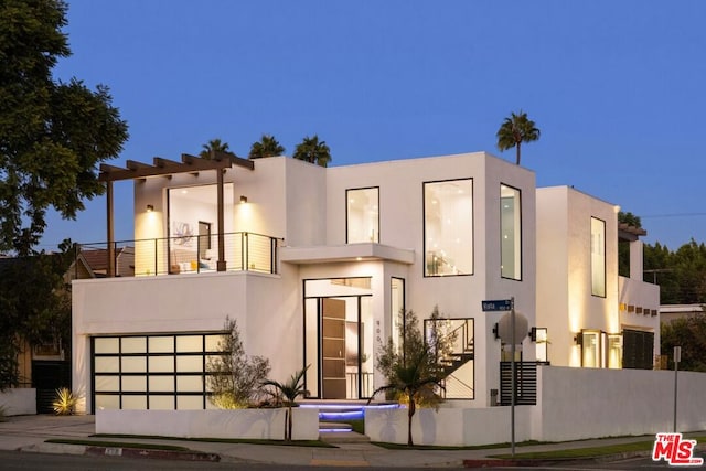 contemporary house featuring a balcony and a garage