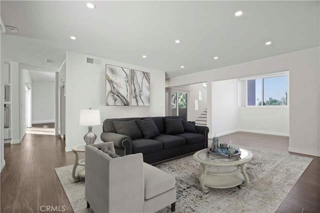 living room with plenty of natural light and dark hardwood / wood-style floors