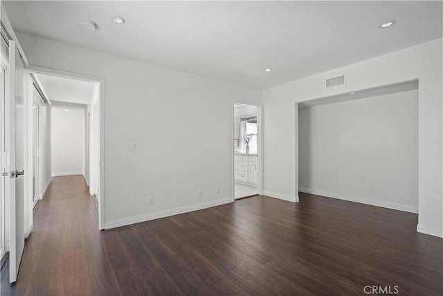 spare room with dark hardwood / wood-style flooring