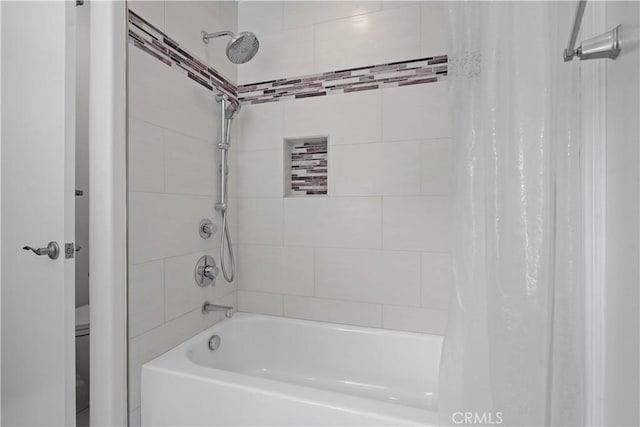 bathroom with shower / bath combo with shower curtain