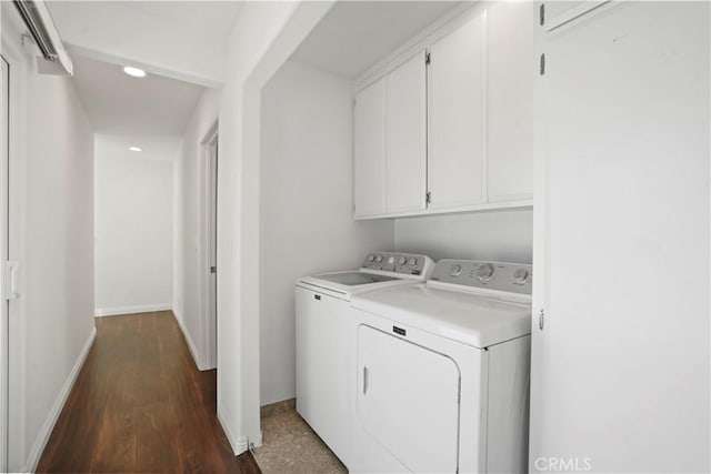 clothes washing area with cabinets, independent washer and dryer, and dark wood-type flooring