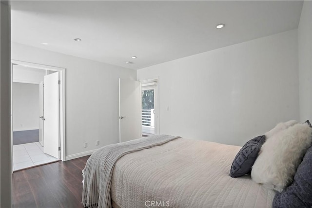 bedroom featuring hardwood / wood-style floors and ensuite bathroom