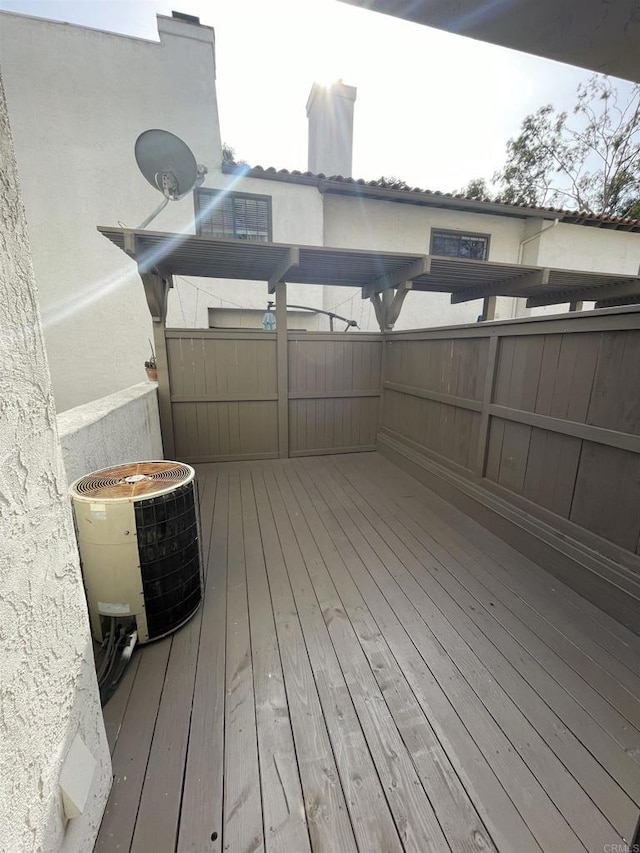 wooden deck featuring central AC unit