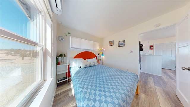 bedroom featuring light hardwood / wood-style flooring and multiple windows