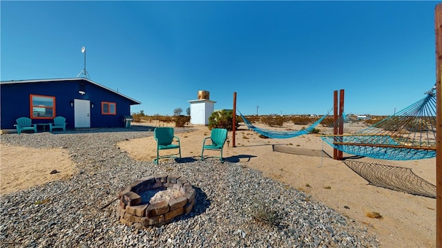 view of playground featuring an outdoor fire pit