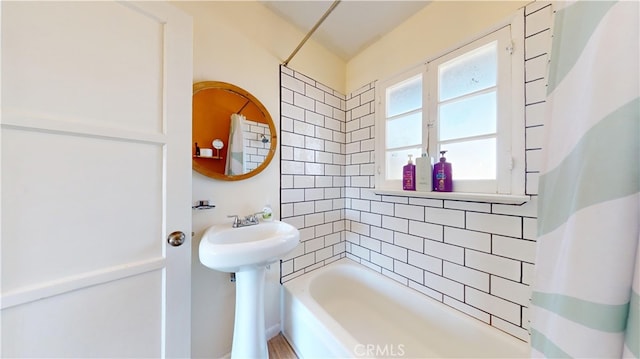 bathroom featuring shower / bathtub combination with curtain