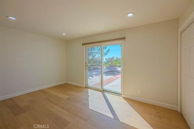 spare room with light hardwood / wood-style flooring