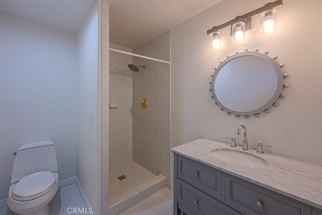 bathroom featuring vanity, tiled shower, toilet, and tile patterned floors