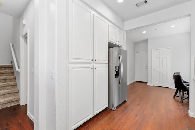 kitchen with white cabinetry, stainless steel fridge, and dark hardwood / wood-style floors