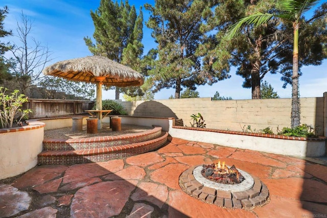 view of patio with area for grilling and an outdoor fire pit