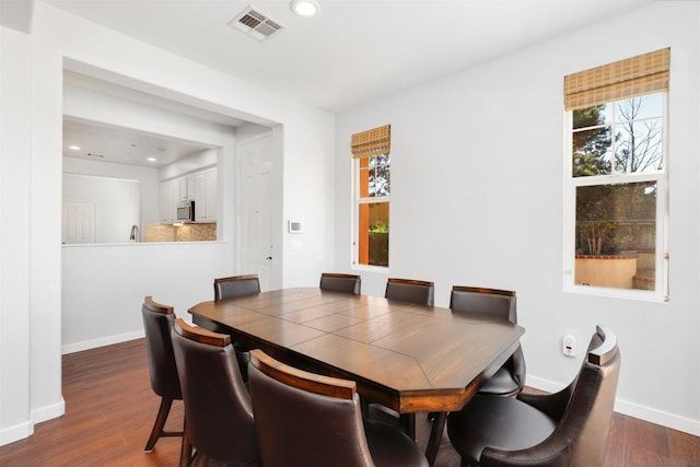 dining area with dark wood-type flooring