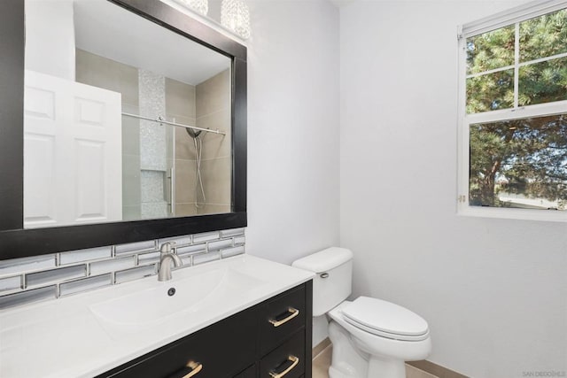 bathroom featuring decorative backsplash, a shower, vanity, and a healthy amount of sunlight