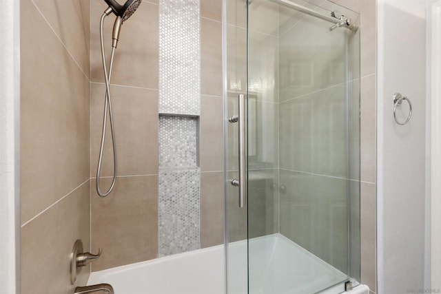 bathroom featuring shower / bath combination with glass door