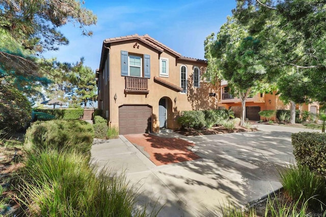 mediterranean / spanish-style home with a garage