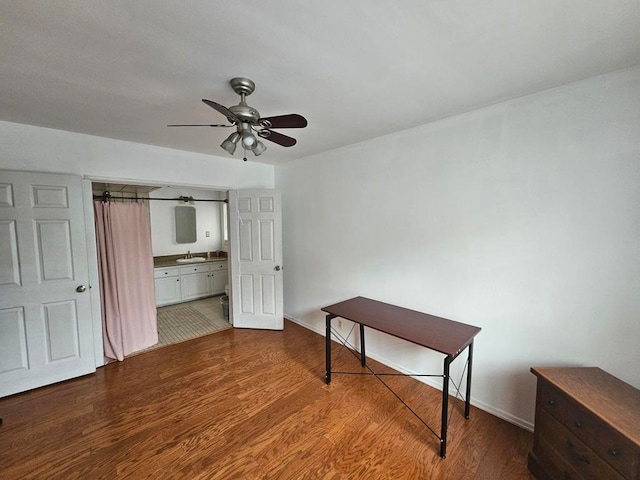 bedroom featuring sink, ensuite bathroom, hardwood / wood-style flooring, and ceiling fan