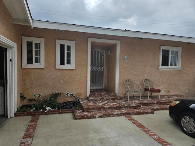 doorway to property with a patio area