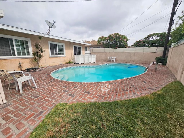 view of swimming pool with a patio area