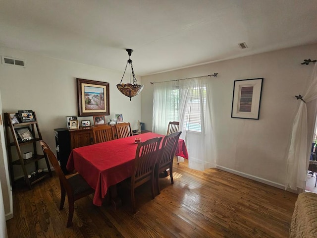 dining space featuring dark hardwood / wood-style floors