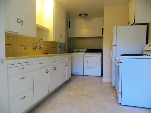 kitchen featuring white cabinetry, sink, backsplash, washing machine and dryer, and white gas stove