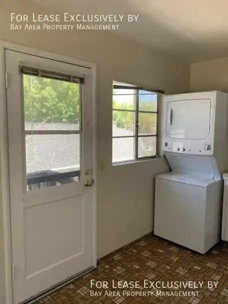 laundry area featuring stacked washer / drying machine