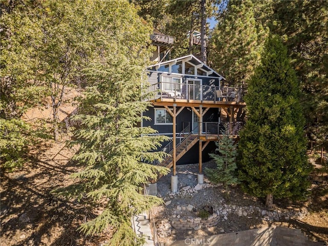 back of house with a wooden deck and stairs