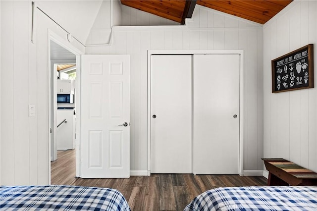 bedroom with wood ceiling, wood finished floors, a closet, and lofted ceiling