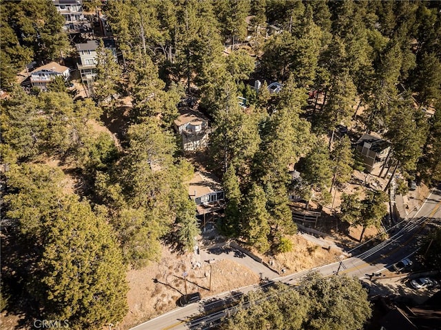 drone / aerial view with a wooded view