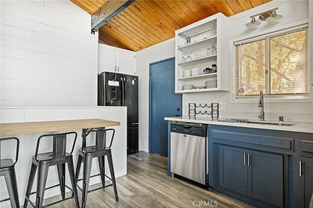 kitchen featuring freestanding refrigerator, wooden ceiling, dishwasher, light countertops, and a sink