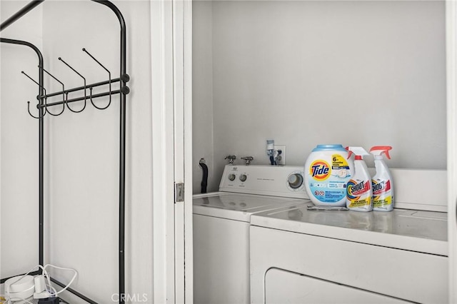 clothes washing area with washer and clothes dryer