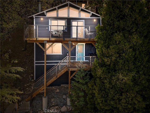 rear view of property featuring a balcony