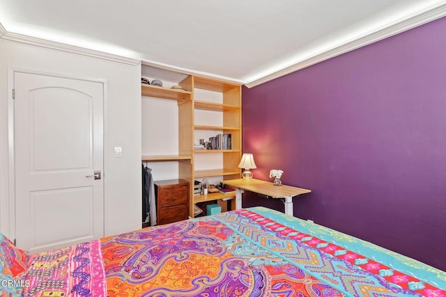 bedroom featuring ornamental molding and a closet