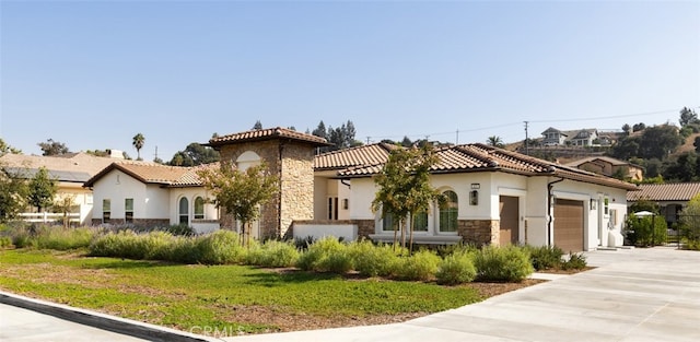 mediterranean / spanish-style home featuring a garage