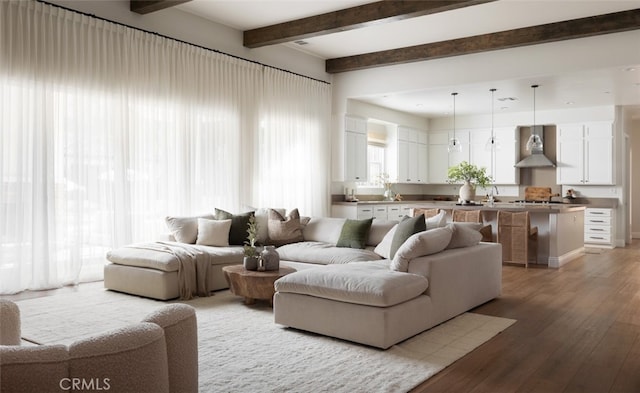 living room featuring light hardwood / wood-style floors and beamed ceiling