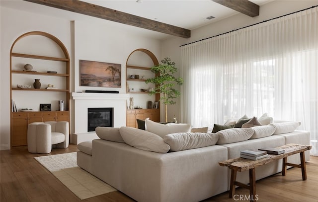 living room with hardwood / wood-style flooring and beamed ceiling