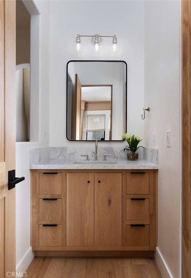 bathroom featuring vanity and wood-type flooring