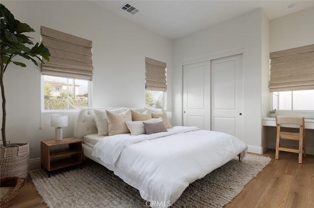 bedroom with a closet and light hardwood / wood-style floors