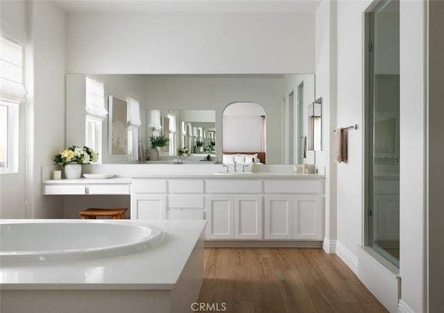 bathroom featuring vanity, a healthy amount of sunlight, an enclosed shower, and hardwood / wood-style floors