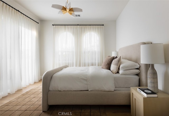 bedroom with tile patterned floors and ceiling fan